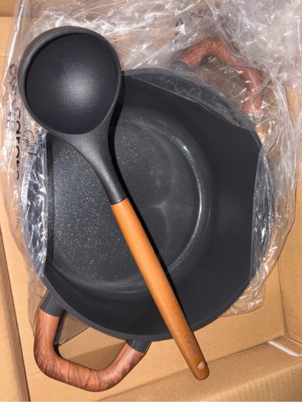 Non-Branded Black Cookware Pot with Brown Wood-Effect Handles and Ladle